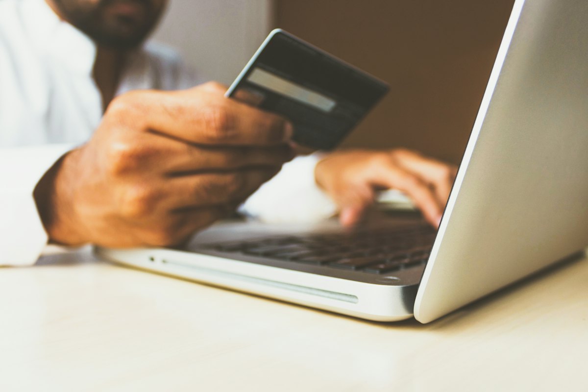 Customer paying by card at a laptop